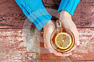 ÃÂ¡up of hot tea with lemon. Hands. Concept of drinks, lifestyle a